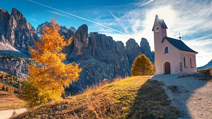 Wooden house surrounded by snow in Selva Val Gardena