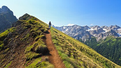 donna_seduta_staccionata_ammira_panorama_montagna_depositphotos